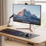 Adjustable standing desk at proper ergonomic height with monitor and keyboard positioned correctly
