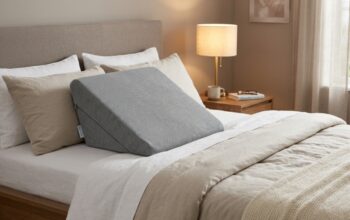 Ergonomic foam wedge pillow on a neutral bed setup.